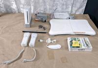 (1) Wii Console W/ Stand, (2) Remote Controllers, (1) Nunchuk Controller, Sensor Bar, AC Adapter & AV Cable, (1) Balance Board & (3) Games