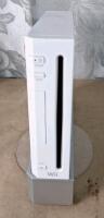 (1) Wii Console W/ Stand, (2) Remote Controllers, (1) Nunchuk Controller, Sensor Bar, AC Adapter & AV Cable, (1) Balance Board & (3) Games - 2