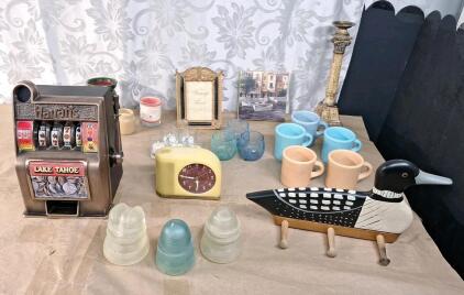 (1) Vintage Harrah's Slot Machine Piggy Bank, (3) Vintage Glass Electrical Insulators, (1) Handcrafted Towel / Keychain Holder, (1) Vintage Westclox Moonbeam Electric Alarm Clock & More