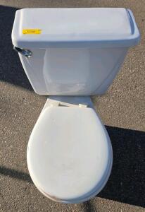 Two-Piece Floor-Mount White Toilet with Tank Lid and Seat, Visible Damage
