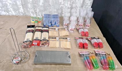 (1) 5" x 12" Stainless Steel Drip Tray, (1) Wire Paper Towel Holder, (3) 100-Count Packs Of 12" Bamboo Skewers, (4) 200-Count Packs Of 4" Bar Bamboo Skewers, (3) 20-Count Packs Of Red Plastic Shot Cups, (2) 24-Count Packs Of Colored Plastic Shot Cups, (5)