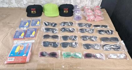 (20) Assorted Pairs Of Sunglasses, (6) Pair Of Bicycle Handlebar Grips, (5) Emergency Ponchos & (3) Baseball Caps