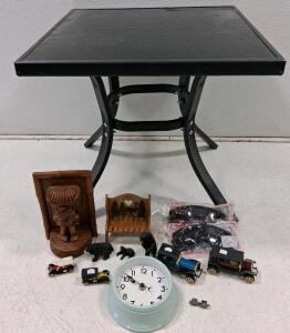 Square Black Metal and Glass Table with Decorative Wood Carvings, Model Cars, Wall Clock, Sunglasses