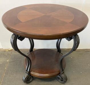 Round Two-Tier Wooden And Metal Accent Table With Ornate Black Metal Base And Lower Shelf