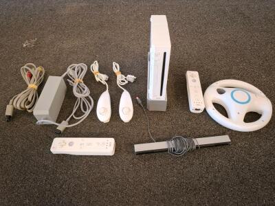 Nintendo Wii Console White Bundle &ndash; 2 Remotes, 2 Nunchuks, Wheel, Sensor Bar, Power Adapter( powered on)