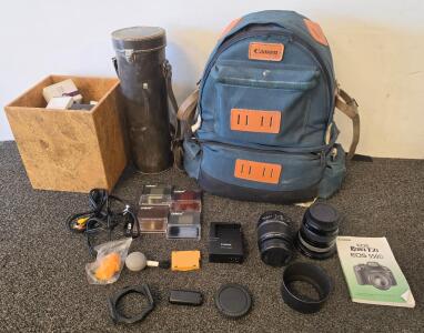 Canon EOS Rebel T2i DSLR Camera Kit With 18-55MM Lens And Accessories, Various Light Bulbs, Cylinder Container, And A Canon Backpack