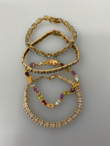 (4) Gold Toned Fancy Bracelets