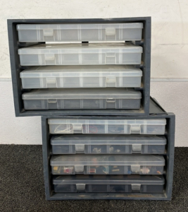 (2) Plano Storage Racks and Assorted Electronics Parts
