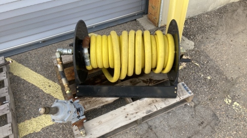 Hand cranking hose reel with pump attached and multipurpose hose