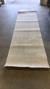 (1) 12’ x 38” Roll Of New Tan Runner Carpet