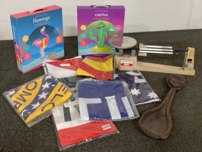 Assortment Of Different Flags, Blow-Up Pool Toys, Beam Balance, And Large Wooden Spoon