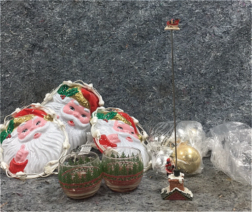 (3) Light Up Santa Claus Faces, (2) Christmas Themed Candles, (1) Bag of Silver and Gold Ordaments, (1) Santa Claus Toy