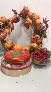 (1) Bowl Of Fake Decoration Grapes, (1) Fall Themed Wreath, (2) Christmas Tins