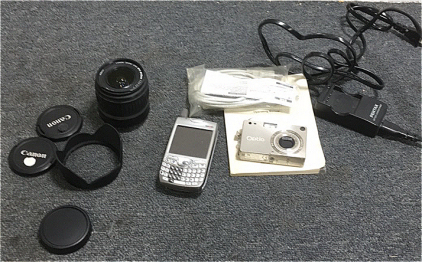 (1) Pentax Optio Digital Camera (1) Canon Zoom Camera Lens (1) Verizon Palm Cellphone