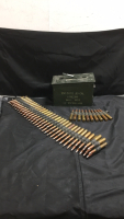 (73) Various Brand .50 Caliber Cartridges On Machine Gun Belt (1) .50 cal Ammo Box