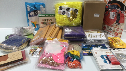 Various Party Supplies: Japanese Photo Props, Plastic Champagne Flutes, Tissue Paper, Purple/Gold Table Covers, Mardi Gras Masks, 9/8 Large Foil Balloons w/ Fairy Lights, Bride To Be, Wood Mothers Day Cards, Eid Mubarak Plates, and more