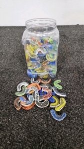Plastic Jar Of Tiny Glass Boomerangs