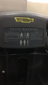 (1) TechnoGym Delts Weight Machine