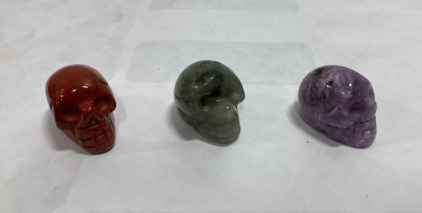 (1) Purple Mica Lepodolite Carved Crystal Skull 61.1 Carat, (1) Labradorite Carved Crystal Skull 61.45 Carat, (1) Red Jasper Crystal Skull 71.9 Carat