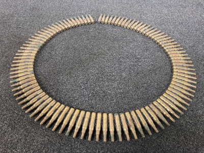 100 rounds of belted ammunition. Appears to be 7.62