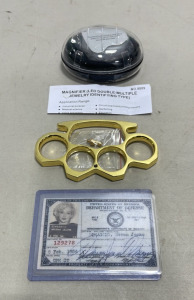 (1) Magnifier (LED Double-Multiple Jewelry Identifying Type, (1) Gold Toned Paper Weight W/ Belt Adapter, (1) Norma Jean USO ID Card Duplicate