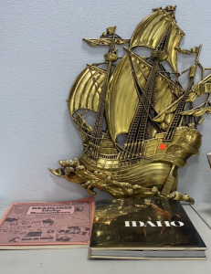 (1) Book Of IDAHO, (1) Headlines Idaho Remembers Book, and a Metal Gold Colored Pirate Ship Decoration