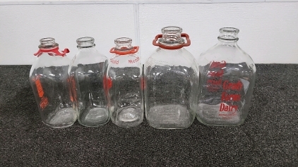 Three Glass Milk Bottles & Two Vintage Glass Milk Gallons