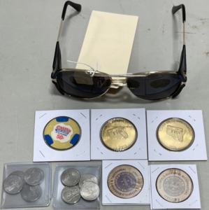 (1) Pair Aviator Sunglasses W/ Side Protectors, (8) Five Cent Pieces, (2) Wooden Nickels, (2) Florida United Numismatists Inc Coins, (1) Rock Island Casino 50 Cent Chip