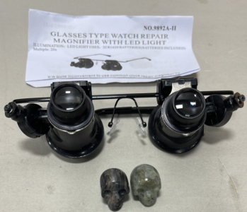 (1) Glasses Type Watch Repair Magnifier With LED Light, (2) Carved Crystal Skulls
