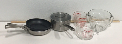 (2) Pyrex Glass Measuring Cups (1) Pampered Chef 8-QT Glass Measuring Cup (1) Simply Calphalon 2Qt Saucepan With Lid (2) 8” Frying Pans