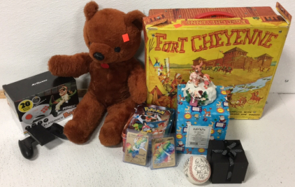 (1) Vintage Fort Cheyenne Playset (1) Teddy Bear (1) Activision Flashback Blast! (1) Nintendo Switch Controller Frame (1) Gen 4 Pokémon Cards w/ Tin (2) Sleeved Vmax Pokémon Cards (1) Signed baseball (1) Rudolph And The Island Of Misfit Toys Statuette