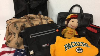 (2) Travel Bags (1) Soft Leather Briefcase (1) Messenger Bag (1) American Flag (1) Childs Greenbay Hoodie (1) Curious George Stuffed Animal (1) Power supply