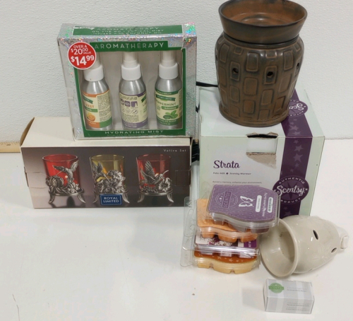 (1) Strata Full-sized Scentsy Warmer (1) Set of Three hummingbird Votives (1) WallPlug Scentsy Warmer (1) Three Pack Aromatherapy Sprays (4) New Scentsy recharge packs