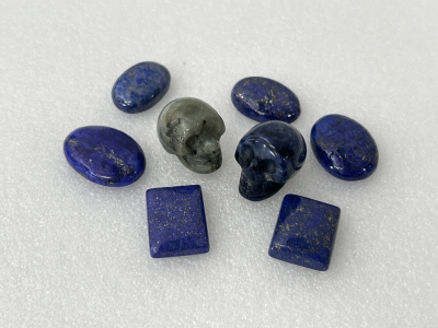 Lapis Lazuli Cabochon Stones and Pair of Crystal Skulls