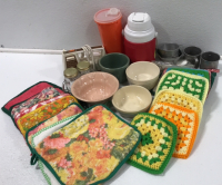 (1) Tupperware Container w/Lid (1) 1/3 Gallon Coleman Jug (1) General Electric Hand Mixer (4) Ceramic Bowls (5) Tin Measuring Cups (1) Glass Jar Salt and Pepper Shaker Set (18) Assorted Potholders (1) Set of 4 Pastry Bag Tips