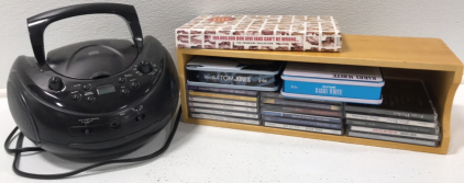 (1) ONN Portable AM/FM, CD Player Boombox (1) Bon Jovi Premier CD Collection (1) Tom Jones Collection- 3CDs (1) Barry White Collection-3CDs (17) CDs by Various Artists (1) CD Wooden Holder