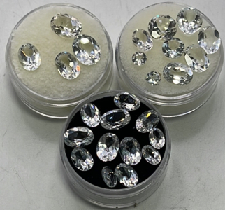 (22) Oval Cut And Faceted White Diamond Topaz Gemstones, (3) Round Cut And Faceted White Diamond Topaz Gemstones