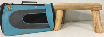 (1) black and light blue Pet Magasin Animal Carrier, (1) Light Brown Wooden Stool, (1) Dark Green Coleman The Powerhouse Camping Latern