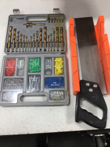 Drill Bit Set With Screws And Wall Plugs. Handheld Saw With Guide.