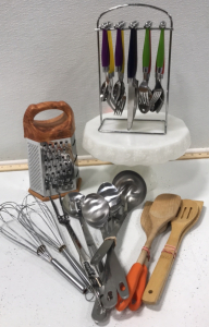 (1) 20pc Hanging Silverware Set (1) Grater (4) Wooden Cooking Utensils (2) Whisks (7) Metal Cooking/Serving Utensils (1) 10&rdquo; Cake Stand