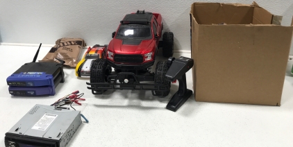 Linksys Wireless-G Broadband Router And Cable Modem. Kenwood Car Radio. New Bright Remote Control Car. (8) MRE. And More.