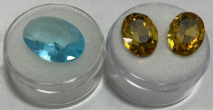 (2) Oval Cut Yellow Sapphires 7.80ct Total, (1) Oval Cut Blue Swiss Glassfield Gemstone 8.75ct