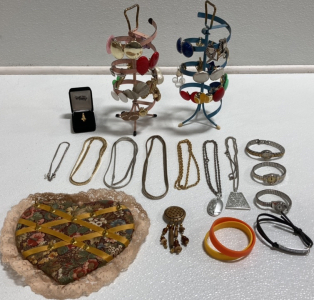 (2) Spinning Jewelry Holders, Heart Necklace Holder, Assorted Clip On Earrings, (3) Simple Women&rsquo;s Watches, Disney&rsquo;s Goofy Pin, Wood Pin, (2) Rubber Bracelets, Inspirational Bracelet, (7) Assorted Necklaces