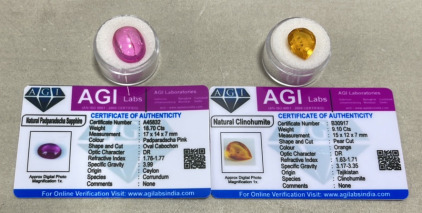 (1) 9.10ct Orange Natural Clinohumite Pear Cut, (1) 18.70ct Natural Padparadscha Sapphire Oval Cabochon