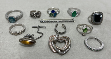 (9) Silver Toned Rings, (1) Gemstone Pin, (1) Tiger Eye Tie Pin