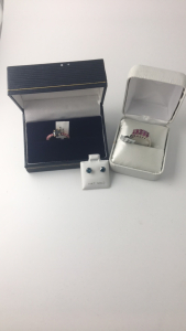(1) Size 7 G. Wt: 4.4 Gms S. Wt: 0.9 Cts Ruby Ring ; (1) Size 5 10K Gold BlackDia 1.25 Ruby 0.36 Ring ; (1) Pair 14kt Gold Blue Diamond 0.9 Ct Earrings