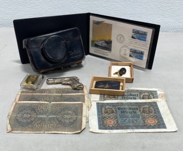 (1) Anita Damascene Belt Buckle And Cufflinks, (1) Kodak Instamatic 500 Camera, (1) 1985 First Day Issue Transpacific Airmail, (5) German Bills, (1) Melted Bar Of Computer Pins Shaped Like Pistol (Contains Gold)