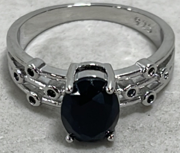 (1) Dark Blue Oval Cut And Faceted Sapphire .925 Ladies Ring Size 8