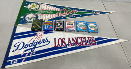 (2) MLB Pennants Dodgers/Oakland A’s, (2) Topps Toys R Us 1991 Baseball Rookies Unopened Packs, (4) Various Boxes Of Baseball Cards