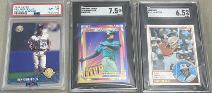 (1) 1992 Fleer Ultra Ken Griffey Jr. Graded #22 NM-MT, (1) 1994 Topps Traded #5 Ken Griffey Jr. Graded 7.5, (1) 1983 Cal Ripken #163 Graded 6.5. All Are Carded And Sleeved